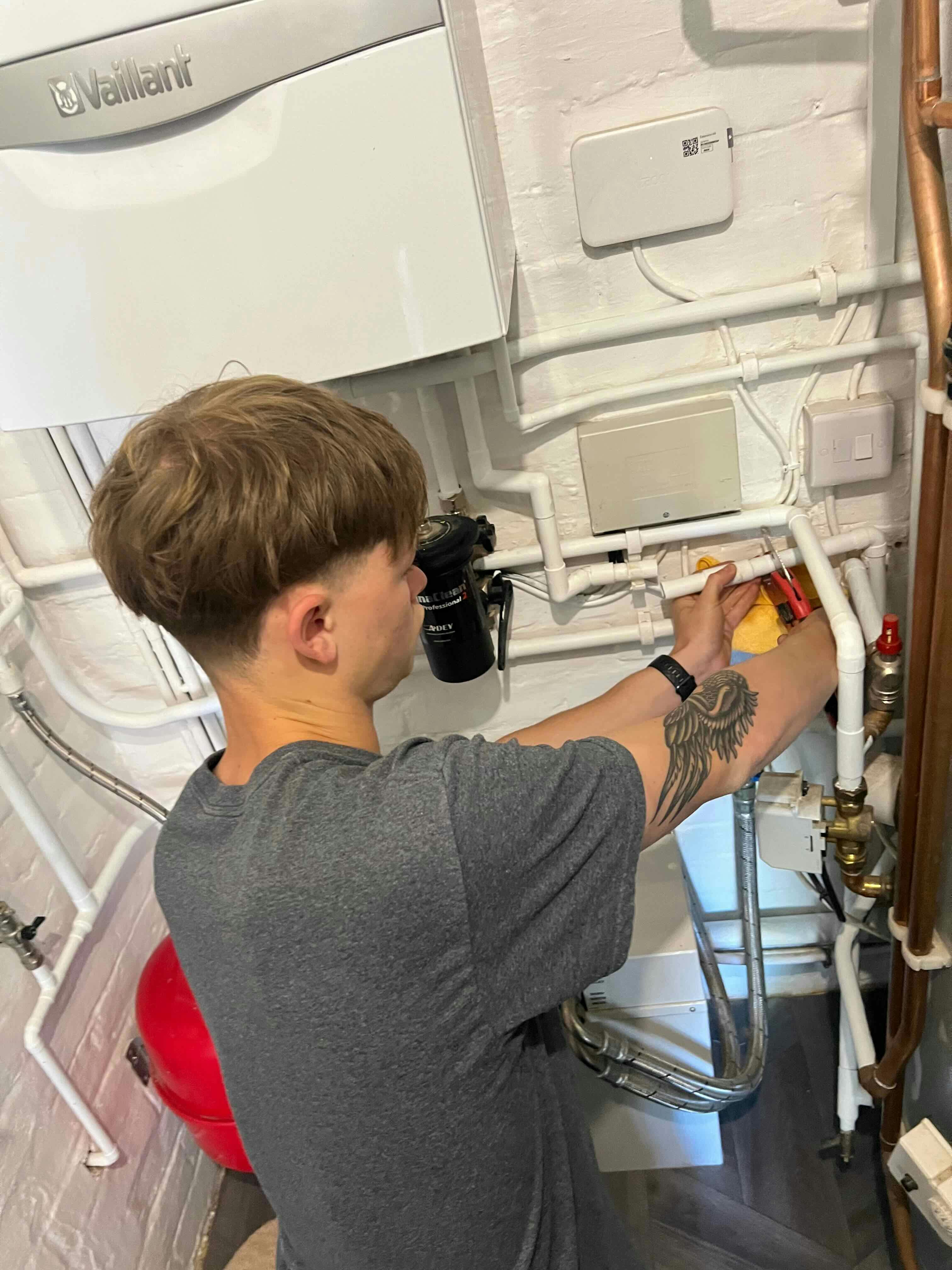 Joseph repairing a leaking pipe identified on a boiler service